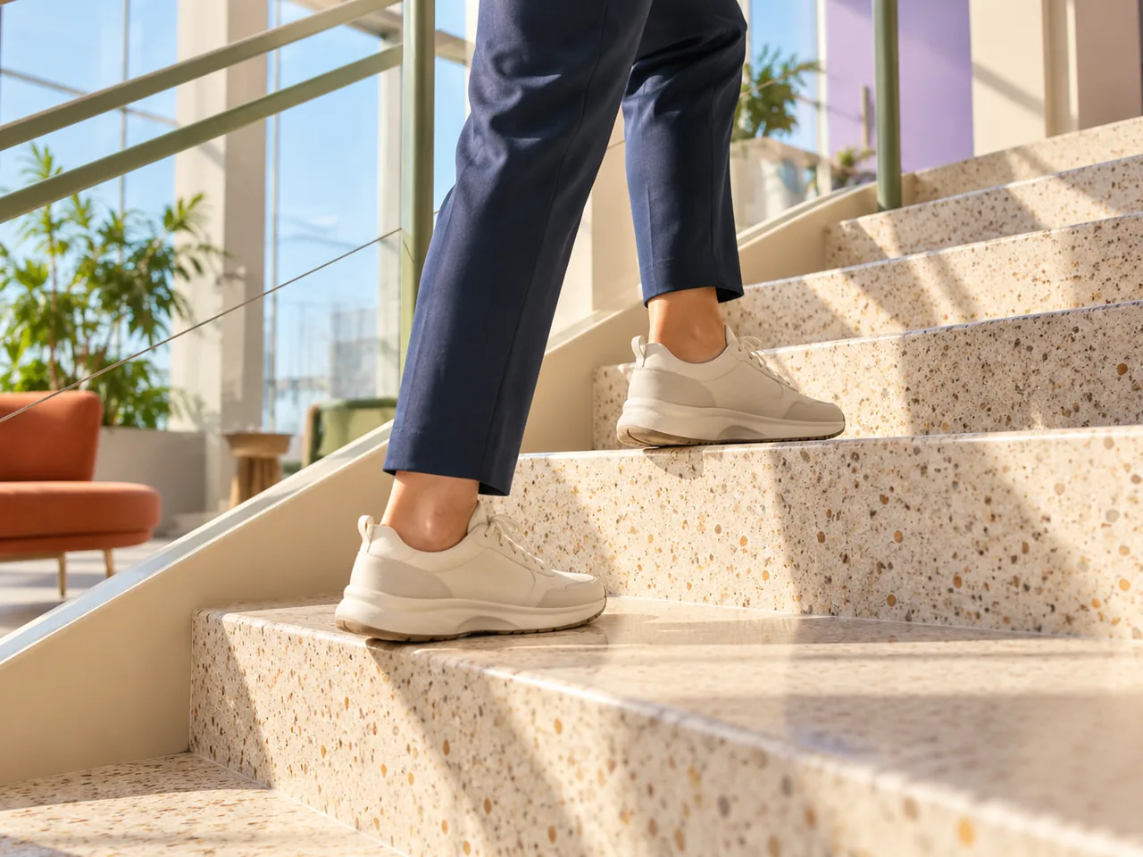 Comfortable shoes stepping up a bright office staircase